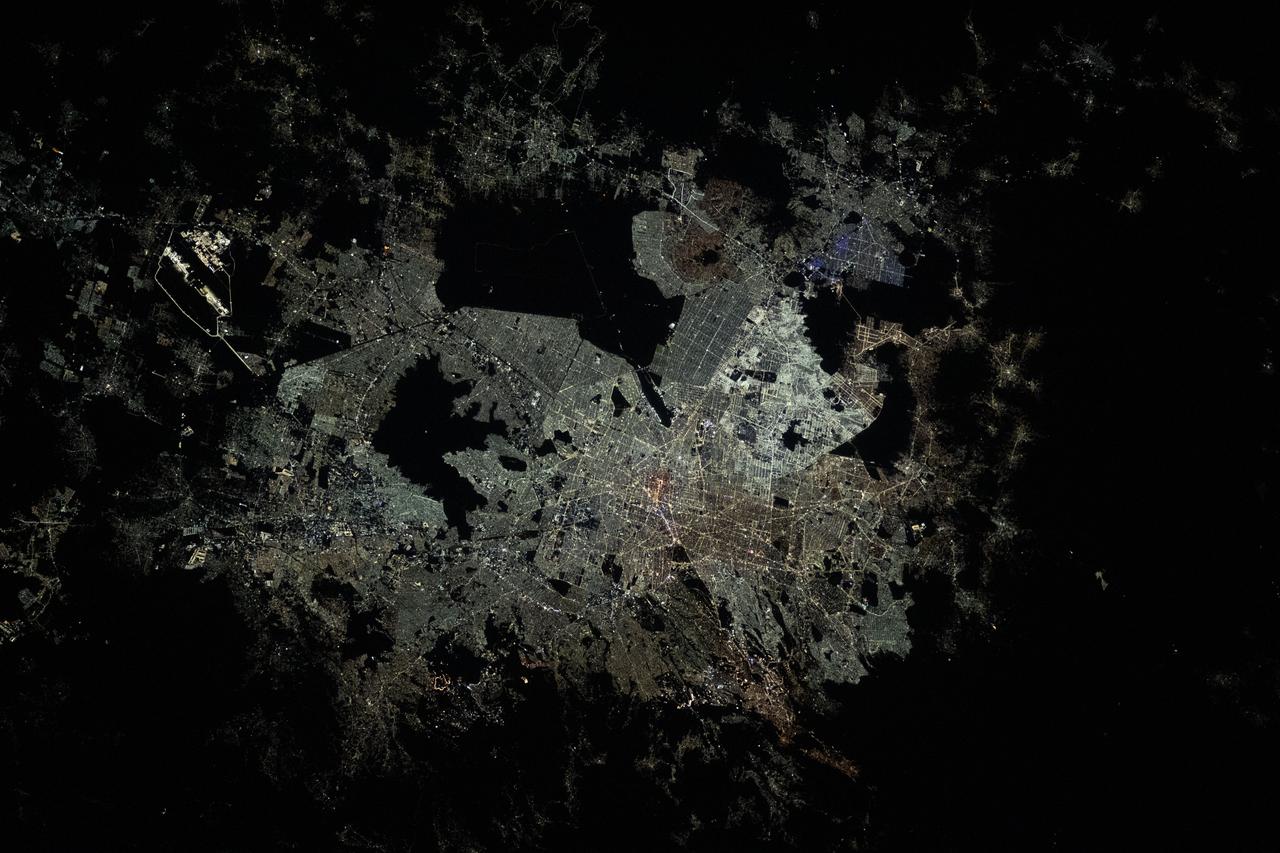 iss070e027906 (Nov. 19, 2023) --- The night lights of Mexico City, the capital and largest city of Mexico with a population of 9.2 million, are pictured from the International Space Station as it orbited 260 miles above the central American nation. At far left, the well-lit Felipe Ángeles International Airport is easily observable from low-Earth orbit. The large, dark area at center top, is Lake Texcoco Ecological Park. The dark area just below, is the Sierra de Guadalupe mountain range.