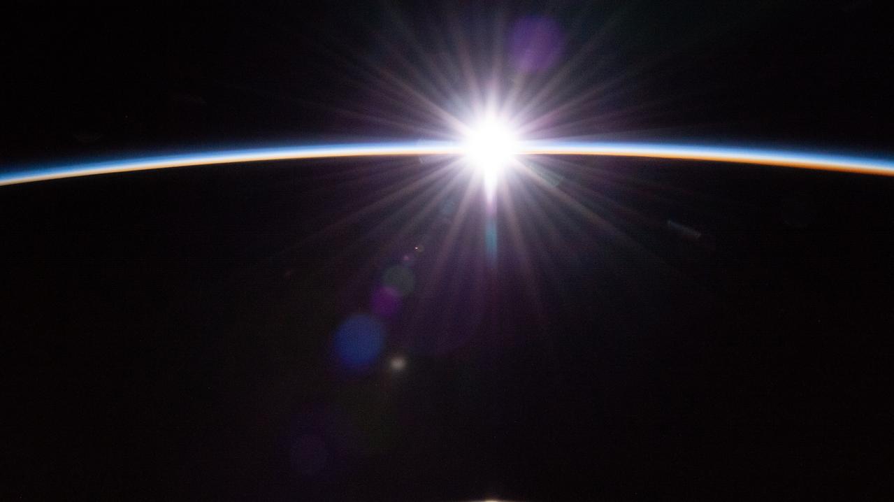 iss070e028899 (Nov. 22, 2023) --- The sun's first rays burst through the Earth's atmosphere in this photograph from the International Space Station as it orbited 264 miles above the Pacific Ocean northwest of New Zealand.