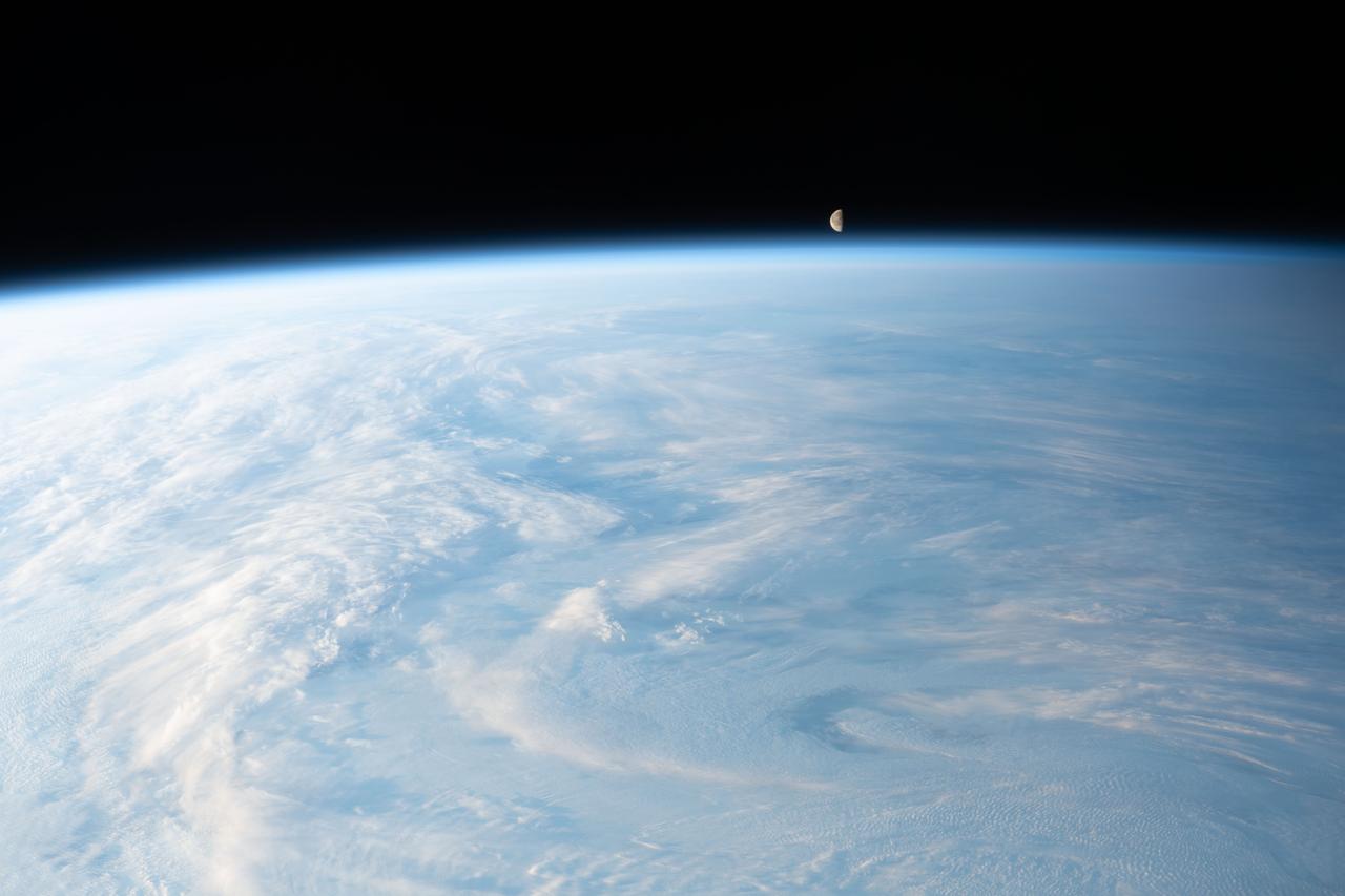 iss070e035253 (Dec. 4, 2023) --- The waning gibbous Moon is pictured just above Earth's horizon in this photograph from the International Space Station as it orbited 262 miles above a cloudy central Asia.