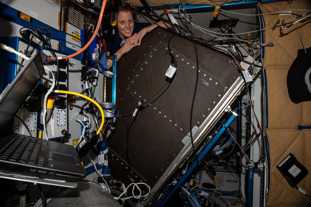 iss070e039886 (Dec. 12, 2023) --- NASA astronaut and Expedition 70 Flight Engineer Loral O'Hara is pictured replacing hardware behind a life support rack inside the International Space Station's Tranquility module.