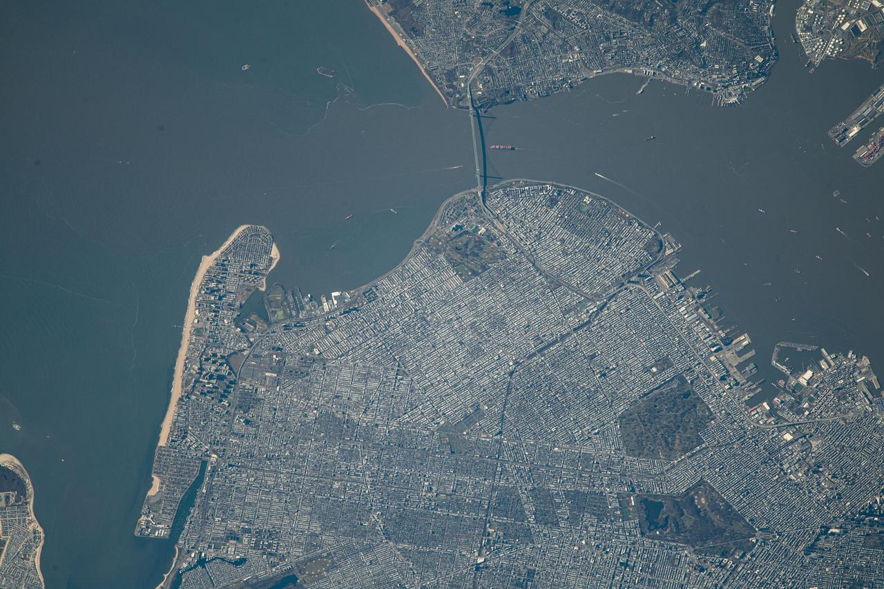 iss070e043429 (Dec. 20, 2023) --- The Verrazano-Narrows bridge connects the New York City boroughs of Staten Island (top) and Brooklyn in this photograph from the International Space Station as it orbited 260 miles above the The Empire State of New York.