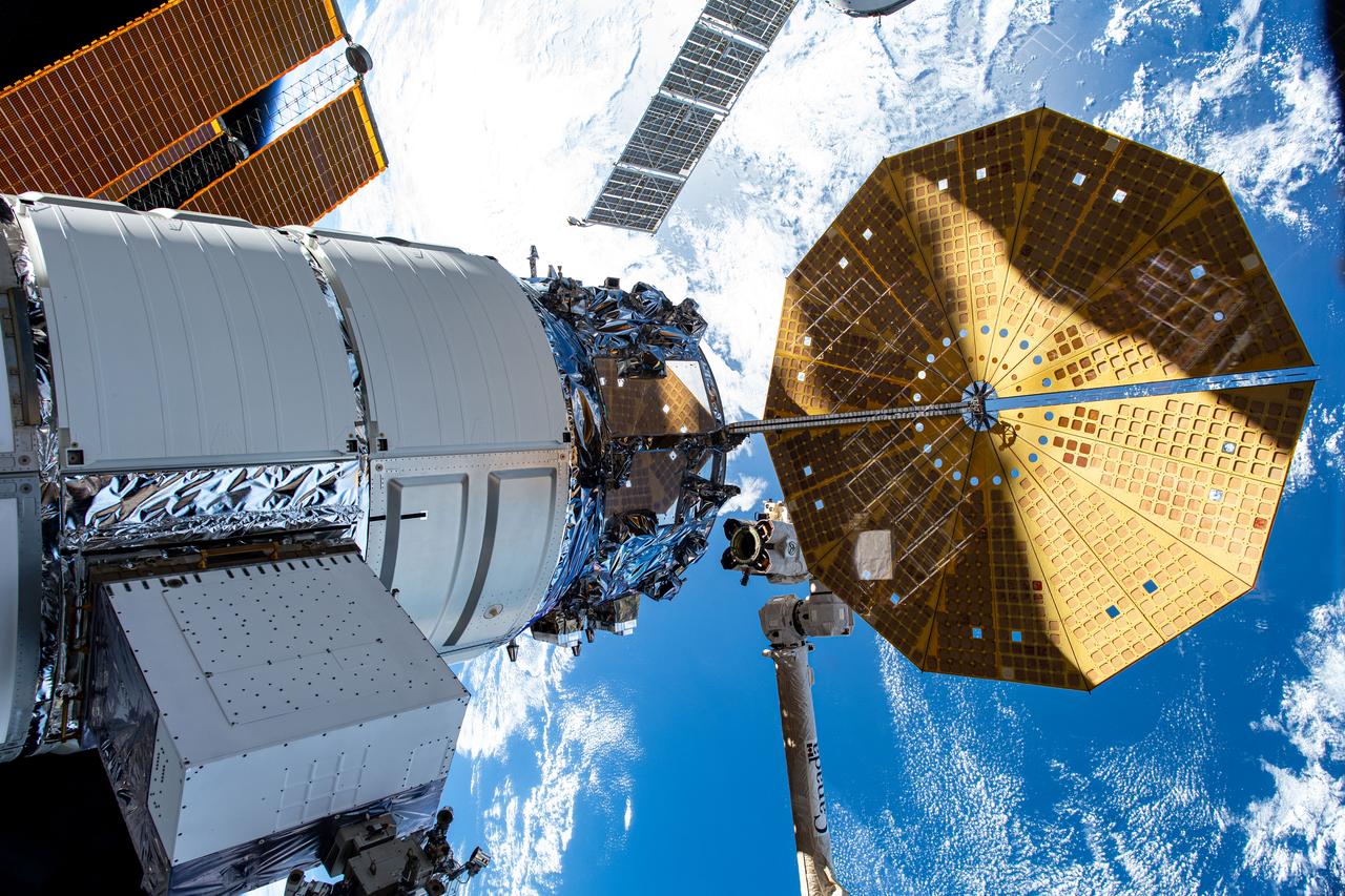 iss070e043722 (Dec. 20, 2023) --- Northrop Grumman's Cygnus space freighter is pictured attached to the International Space Station while orbiting 264 miles above the Indian Ocean south of the island nation of Madagascar. At lower center, is the Canadarm2 robotic arm preparing to grapple Cygnus ahead of its removal from the Unity module and departure from the orbital outpost.