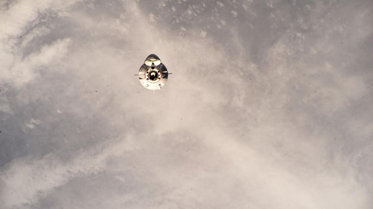 iss070e075551 (Jan. 20, 2024) --- The SpaceX Dragon Freedom spacecraft carrying the four-member Axiom Mission 3 (Ax-3) crew is pictured approaching the International Space Station 264 miles above a cloudy Indian Ocean east of the coast of Madagascar.