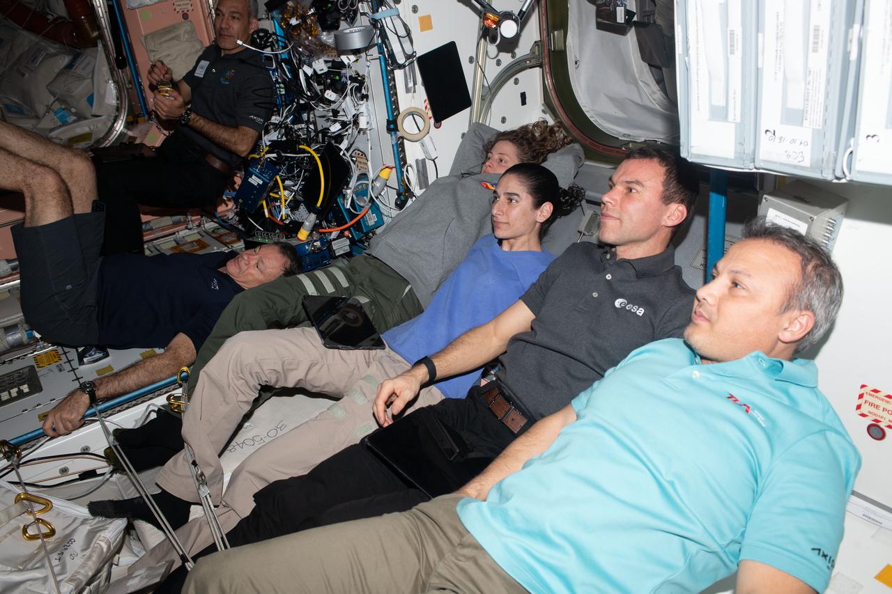 iss070e083382 (Jan. 27, 2024) --- Members of the Axiom Mission 3 (Ax-3) and Expedition 70 crews join each other for movie night inside the International Space Station's Harmony module. From left are, Ax-3 Pilot Walter Villadei; Ax-3 Commander Michael López-Alegría; Expedition 70 Flight Engineers Loral O'Hara and Jasmin Moghbeli, both from NASA; and Ax-3 Mission Specialists Marcus Wandt and Alper Gezeravcı.