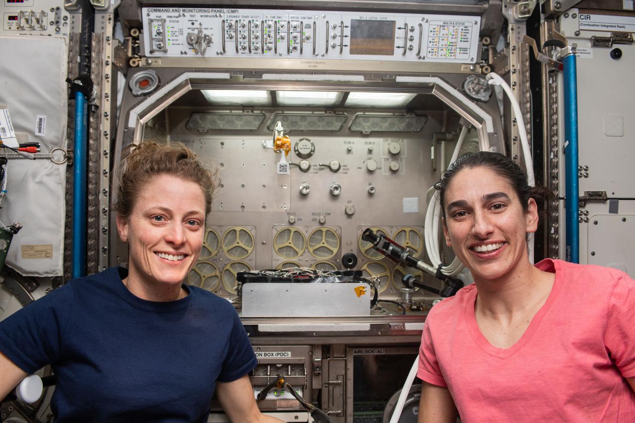 iss070e085869 (Feb. 2, 2024) --- Expedition 70 Flight Engineers (from left) Loral O'Hara and Jasmin Moghbeli are pictured in front of the Microgravity Science Glovebox, a research facilty that can host a variety of biology and physics experiments, located in the International Space Station's Destiny laboratory module.