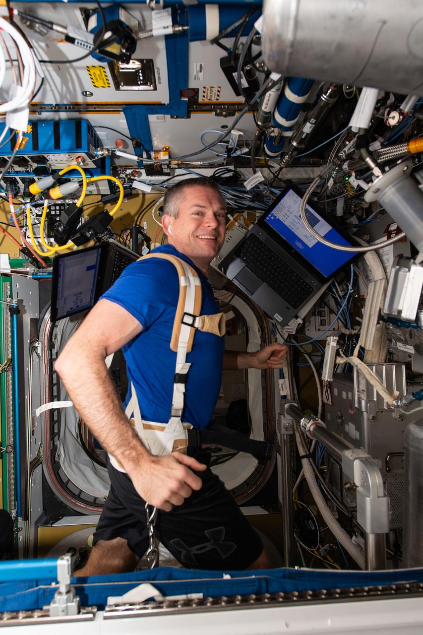 iss070e087271 (Feb. 5, 2024) --- ESA (European Space Agency) astronaut and Expedition 70 Commander Andreas Mogensen jogs while strapped to a treadmill inide the International Space Station's Tranquility module.