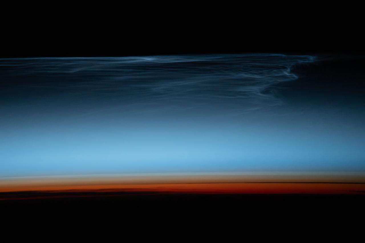 iss070e090453 (Feb. 10, 2024) --- Noctilucent clouds, wispy clouds in Earth's upper atmosphere illuminated by the sunlight just after sunset, are pictured from the International Space Station as it orbited 269 miles above the south Pacific Ocean.