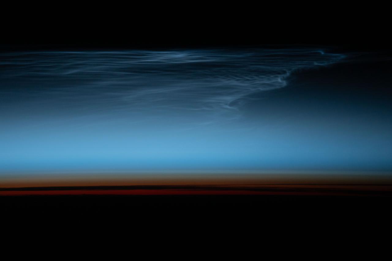 iss070e090457 (Feb. 10, 2024) --- Noctilucent clouds, wispy clouds in Earth's upper atmosphere illuminated by the sunlight just after sunset, are pictured from the International Space Station as it orbited 269 miles above the south Pacific Ocean.