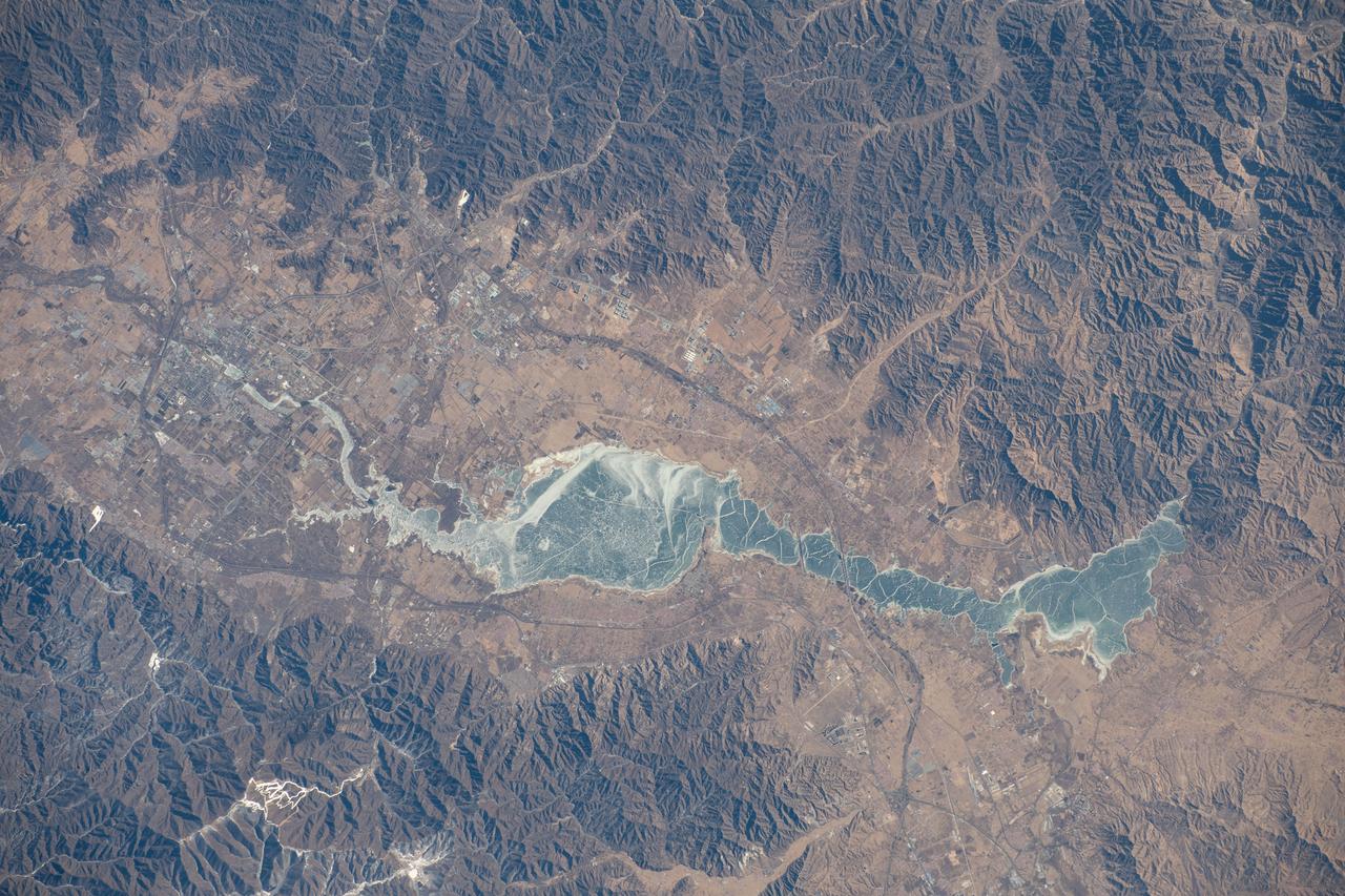 iss070e093517 (Feb. 15, 2024) --- The Guanting Reservoir, northwest of Beijing, China, and surrounded by several smaller cities, is pictured from the International Space Station as it orbited 262 miles above.