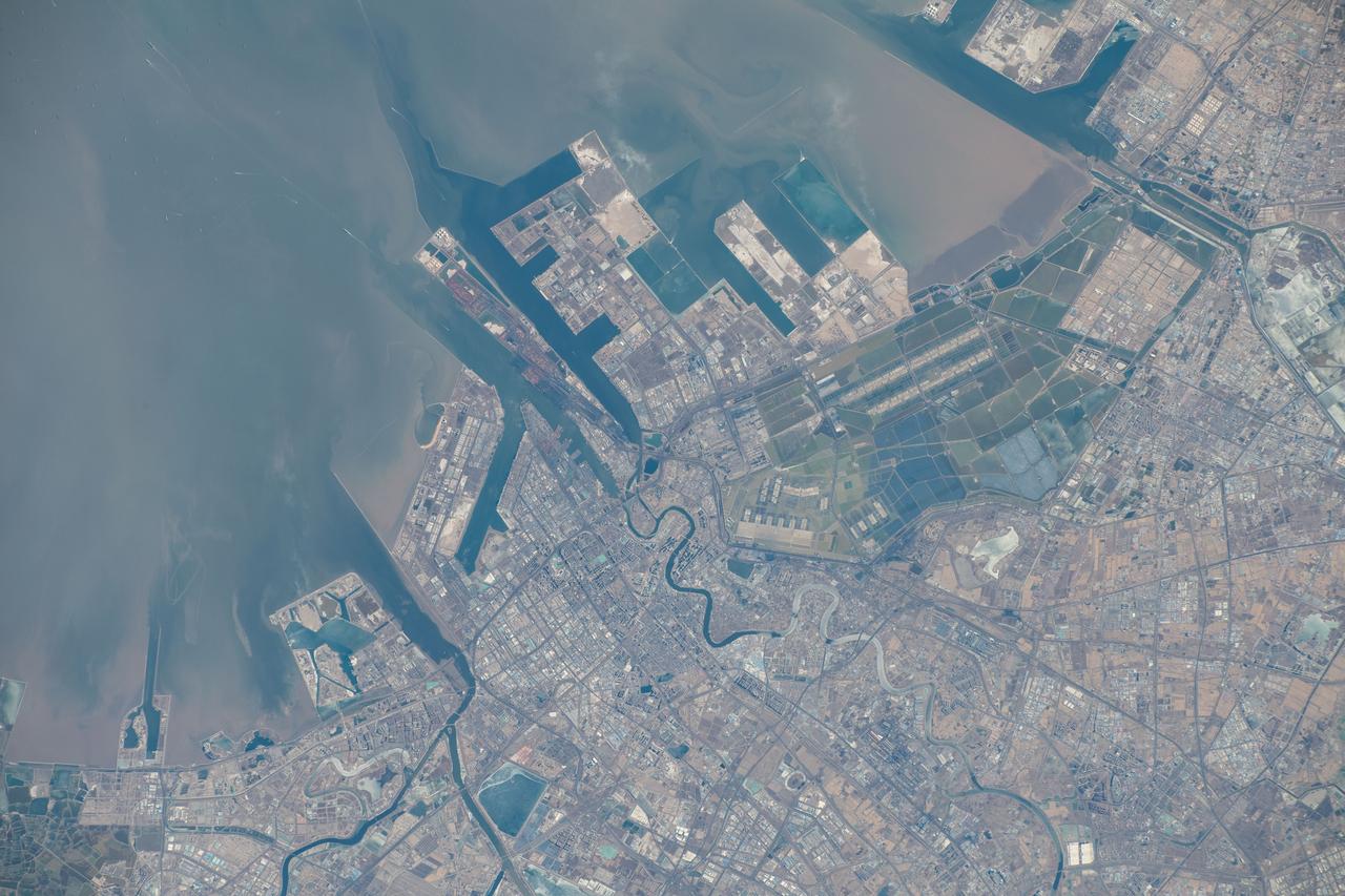 iss070e093551 (Feb. 15, 2024) --- The port of Tianjin, China, on the Bohai Sea, a city with a population of over 13.8 million and known for its high scientififc output, is pictured from the International Space Station as it orbited 262 miles above.