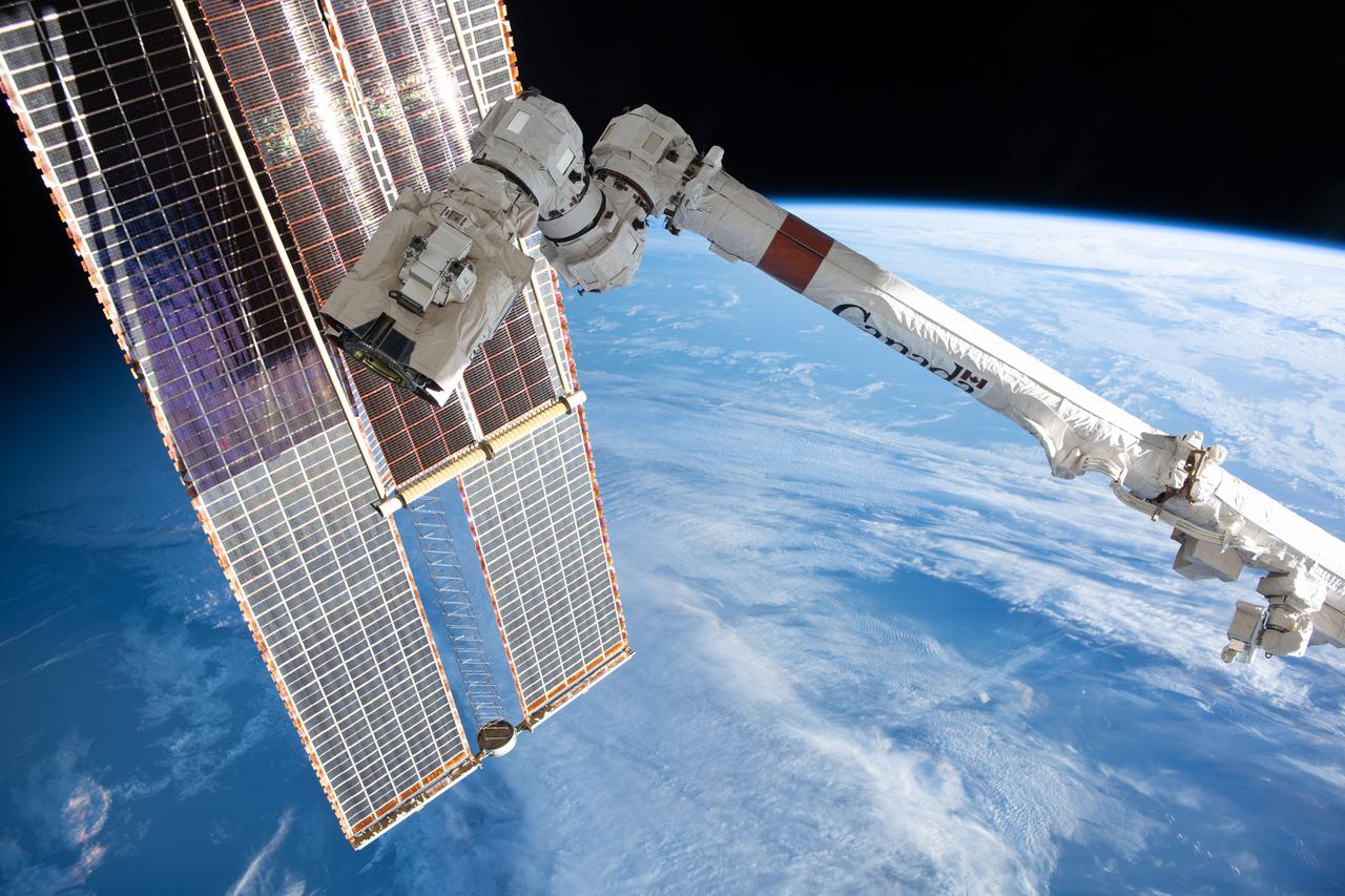 iss070e095147 (Feb. 18, 2024) --- A set of the International Space Station's main solar arrays, a pair of smaller rollout solar arrays, and the Canadarm2 robotic arm with the latching end eeffector on its tip, are pictured as the orbital complex soared 263 miles above the Atlantic Ocean near the coast of Ireland.