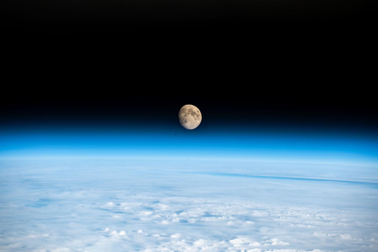 iss070e097393 (Feb. 21, 2024) --- The waxing gibbous Moon is pictured above the Earth's horizon in this photograph from the International Space Station as it orbited 262 miles above a cloudy Western Europe.