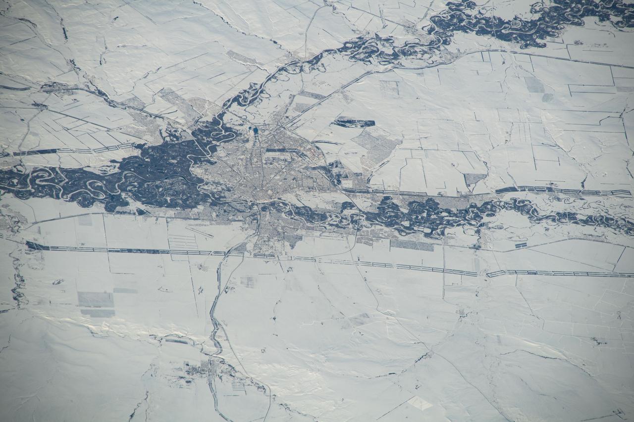 iss070e097619 (Feb. 11, 2024) --- Orenburg, Russia, surrounded by a wintry landscape, the Sakmara and Ural Rivers, and near the border with Kazakhstan, is pictured from the International Station as it orbited 263 miles above the area where Eastern Europe meets central Asia.