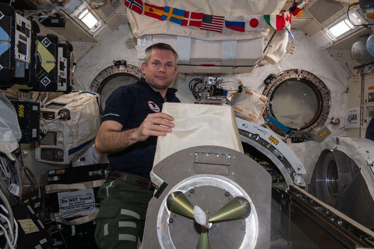 iss070e098166 (Feb. 22, 2024) --- ESA (European Space Agency) astronaut and Expedition 70 Commander Andreas Mogensen removes the multipurpose experiment platform (MPEP) from the Kibo laboratory module's airlock. External science payloads are attached to the MPEP which is then placed inside Kibo's airlock. Next, the airlock is depressurized before the Japanese robotic arm grapples the MPEP and places it on Kibo's Exposed Facility where external science experiments are deployed.