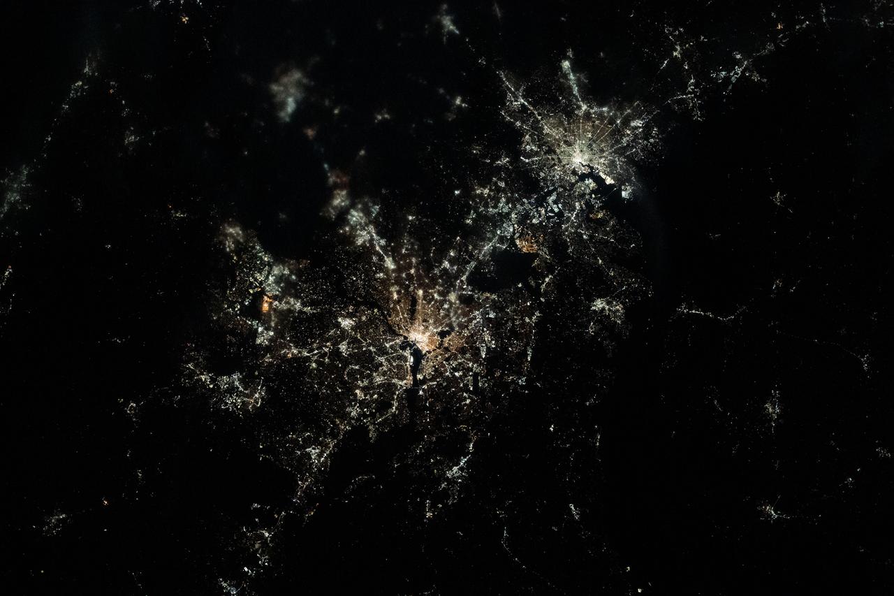 iss070e098464 (Feb., 23, 2024) --- This nighttime, near overhead view shows Washington, D.C. (center) and Baltimore, Maryland (upper right) on Chesapeake Bay. Expedition 70 Flight Engineer Loral O'Hara of NASA photographed the area as the International Space Station orbited 261 miles above.