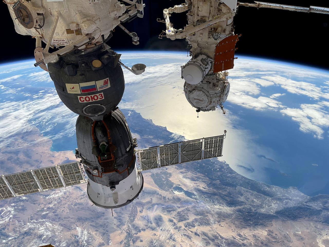 iss070e103141 (Nov. 28, 2023) --- At left, the Soyuz MS-24 crew ship is docked to the Rassvet module and at right, the Prichal docking module is attached to the Nauka module. Also pictured attached to Nauka in this photograph from Expedition 70 Flight Engineer Konstantin Borisov, are a science airlock and the European robotic arm as the International Space Station soared 261 miles above the southwestern United States. Credit: Roscosmos