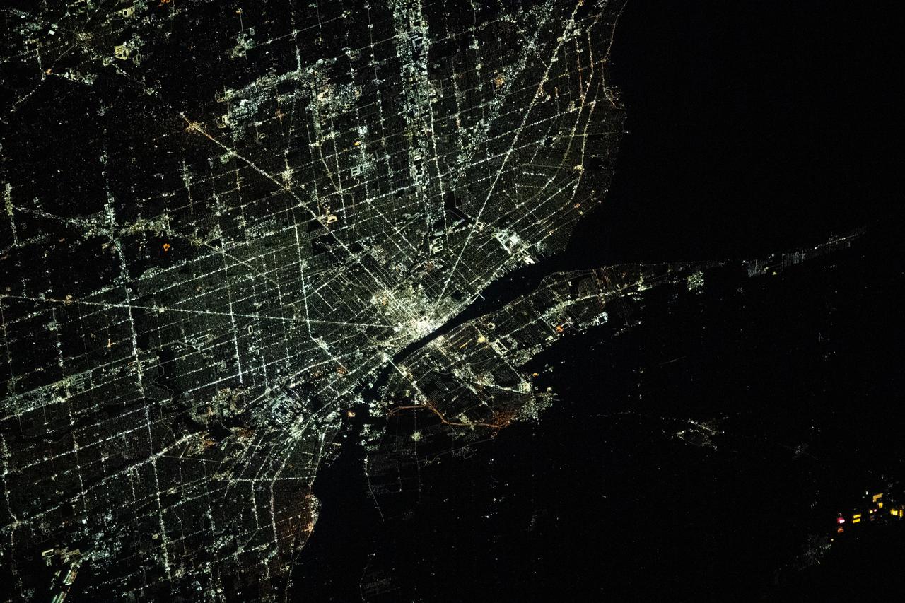 iss070e105102 (March 1, 2024) --- The city lights of Detroit, Michigan, separated from the city of Windsor in Ontario, Canada, by the Detroit River, are pictured from the International Space Station as it orbited 264 miles above.