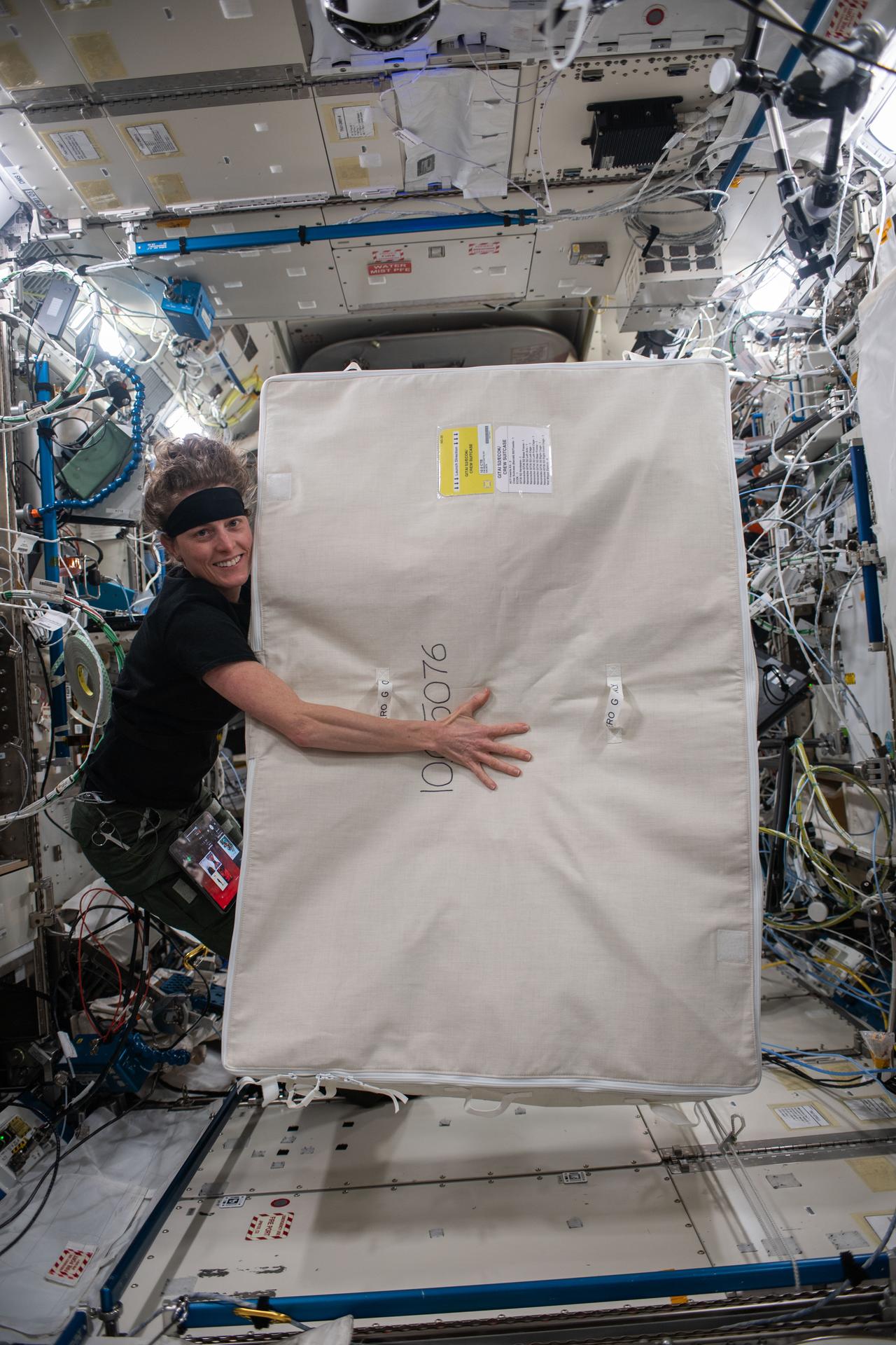 NASA astronaut and Expedition 70 Flight Engineer Loral O'Hara holds a cargo transfer bag containing life support hardware inside the International Space Station's Kibo laboratory module.