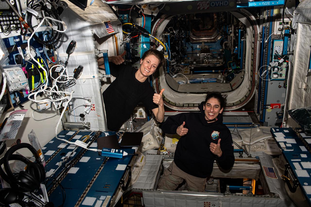 iss070e106199 (March 4, 2024) ---Expedition 70 Flight Engineers (from left) Loral O'Hara and Jasmin Moghbeli, both NASA astronauts who also reside in Texas, give a thumbs up after voting from the International Space Station. The duo filled out electronic absentee ballots that were downlinked to Mission Control Center in Houston, Texas, then sent to the county clerk's office.