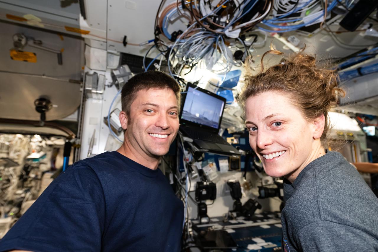 iss070e128430 (March 23, 2024) --- Expedition 70 Flight Engineers Matthew Dominick and Loral O'Hara, both NASA astronauts, smile for a portrait shortly after the SpaceX Dragon cargo craft docked to the International Space Station.