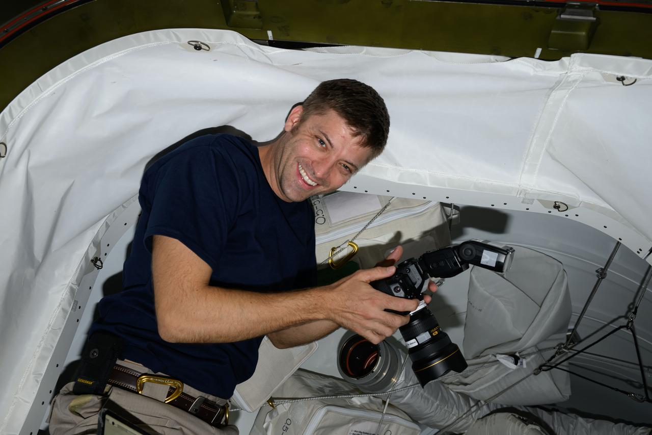 iss070e128588 (March 23, 2024) --- Expedition 70 Flight Engineer and NASA astronaut Matthew Dominick smiles for a portrait during photography duties aboard the International Space Station.