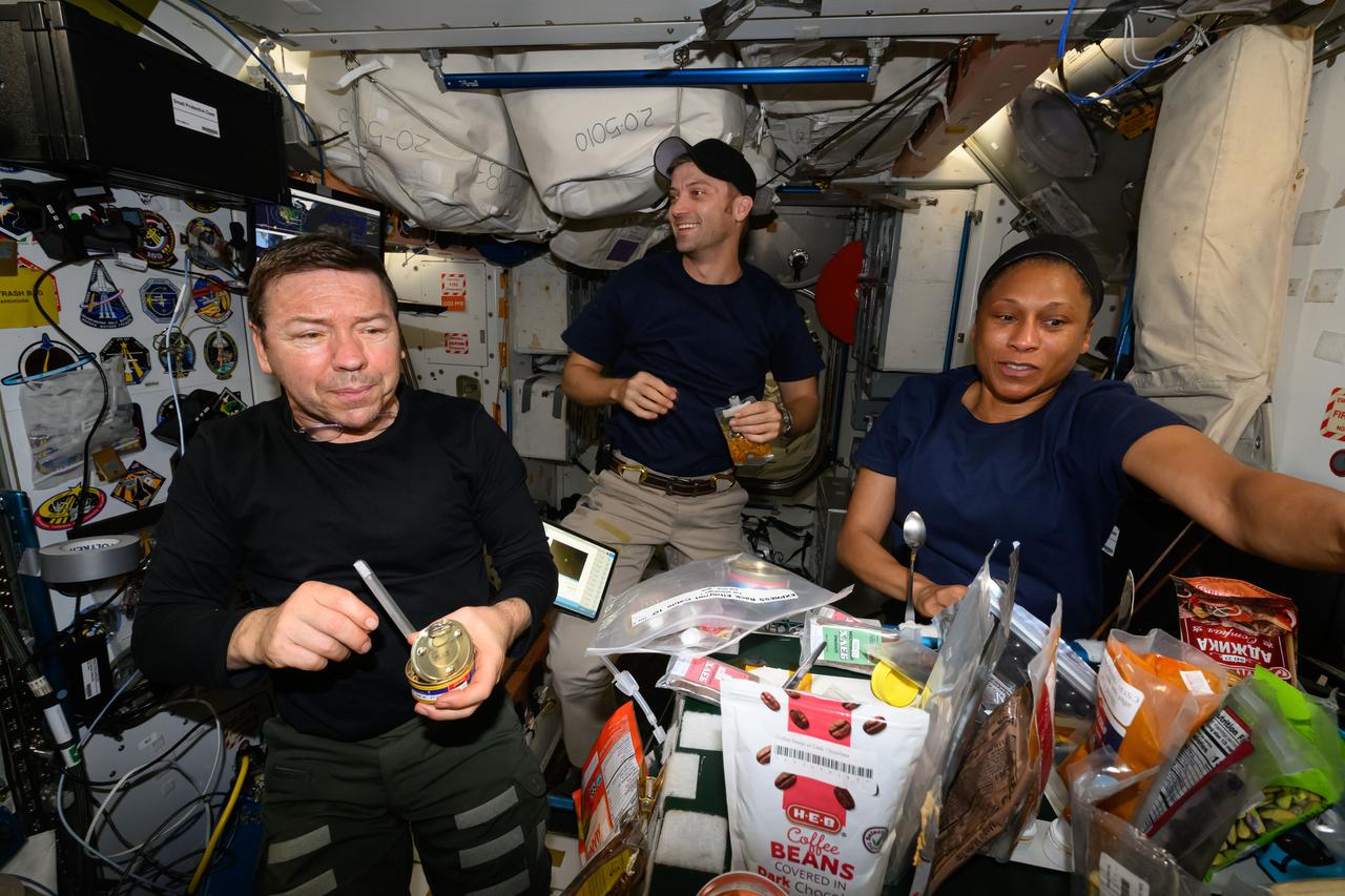 iss070e128806 (March 24, 2024) --- Expedition 70 Flight Engineers (from left) Mike Barratt, Matthew Dominick, and Jeanette Epps enjoy breakfast on a Sunday morning inside the International Space Station's Unity Module.