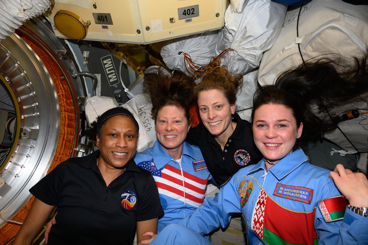 iss070e129692 (March 25, 2024) --- Posing for a portrait aboard the International Space Station (from left) are, NASA astronauts Jeanette Epps, Tracy C. Dyson, and Loral O'Hara, and Belarus spaceflight participant Marina Vasilevskaya. Dyson and Vasilevskaya, along with Roscosmos cosmonaut Oleg Novitskiy (out of frame), were the newest visitors to the orbital outpost after docking to the Prichal docking module aboard the Soyuz MS-25 crew ship.