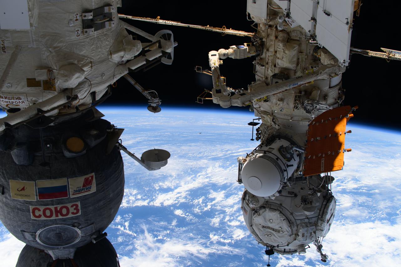 iss070e129816 (March 25, 2024) --- Just a tiny image in the center of this photograph, the Soyuz MS-25 crew ship carrying three crew members is pictured approaching the International Space Station for a docking to the Poisk module. Aboard the Soyuz MS-25 were, NASA astronaut Tracy C. Dyson, Roscosmos cosmonaut Oleg Novitskiy, and Belarus spaceflight participant Marina Vasilevskaya. At left, is the Soyuz MS-24 crew ship docked to the Rassvet module, and at right, is the Prichal docking module attached to the Nauka science module.