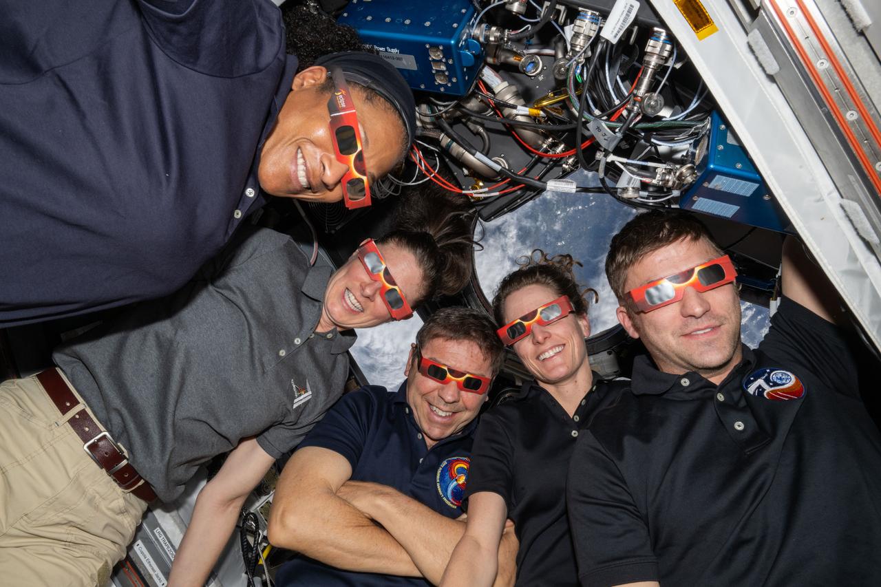 iss070e129908 (March 26, 2024) --- Five NASA astronauts wear eye-protecting specs in anticipation of viewing the solar eclipse from the International Space Station's cupola. The Expedition 70 crewmates will have three opportunities on April 8 to view the Moon's shadow as it tracks across the Earth surface during the eclipse.