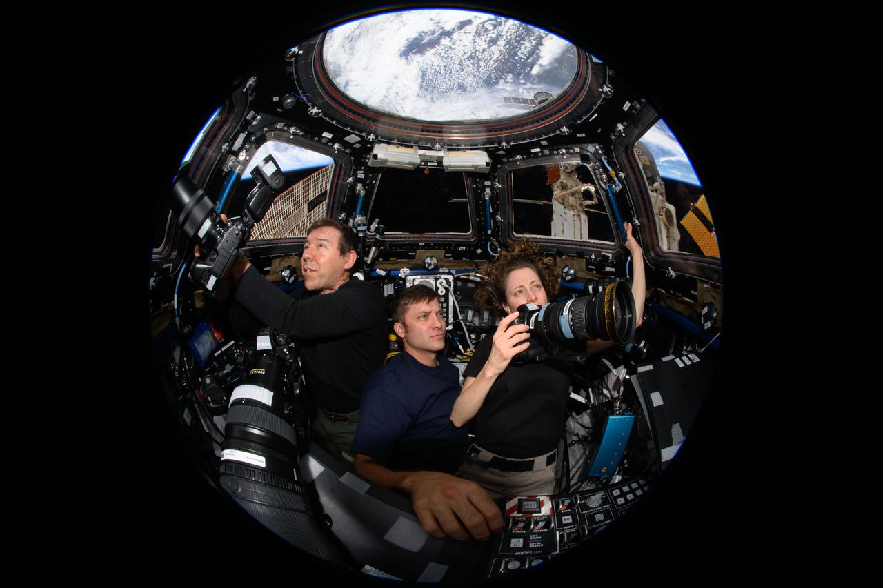 iss070e132878 (March 31, 2024) --- Expedition 70 Flight Engineers (from left) Mike Barratt, Matthew Dominick, and Loral O'Hara participate in an Earth photography session inside the cupola, the International Space Station's "window to the world." The orbital complex was soaring 259 miles above West Virginia in the United States at the time of this photograph.
