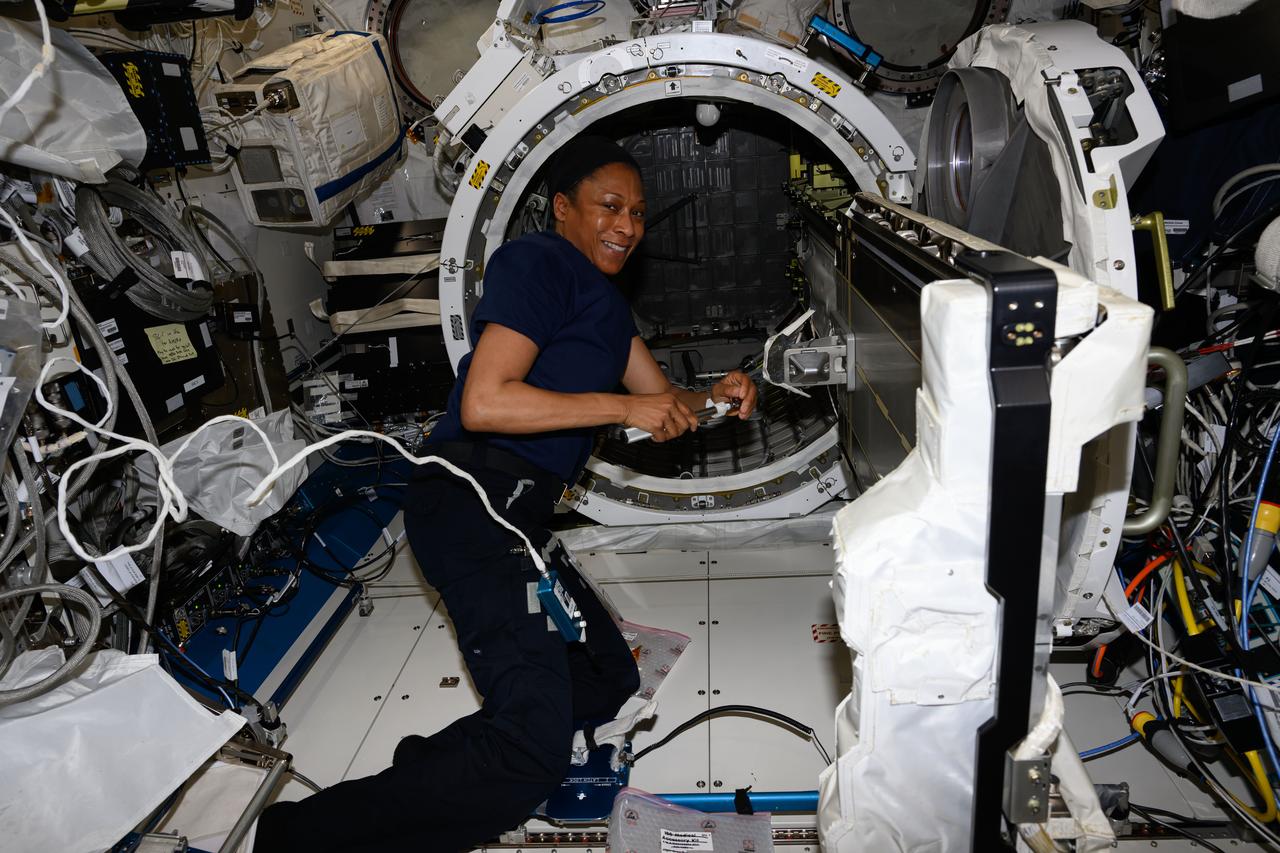iss071e001359 (April 8, 2024) --- Expedition 71 Flight Engineer and NASA astronaut Jeanette Epps installs a small satellite orbital deployer inside the Kibo laboratory module’s airlock. Packed inside the device are three CubeSats for deployment into Earth orbit for a variety of communications and technology studies.