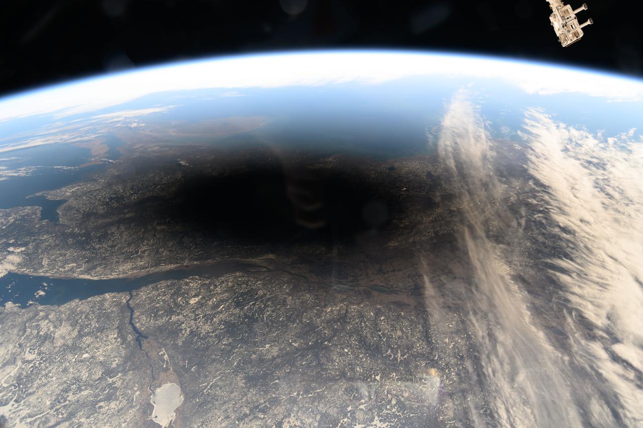 iss071e002844 (April 8, 2024) --- The Moon's shadow, or umbra, is pictured covering portions of the Canadian provinces of Quebec and New Brunswick and the American state of Maine in this photograph from the International Space Station as it soared into the solar eclipse from 261 miles above.