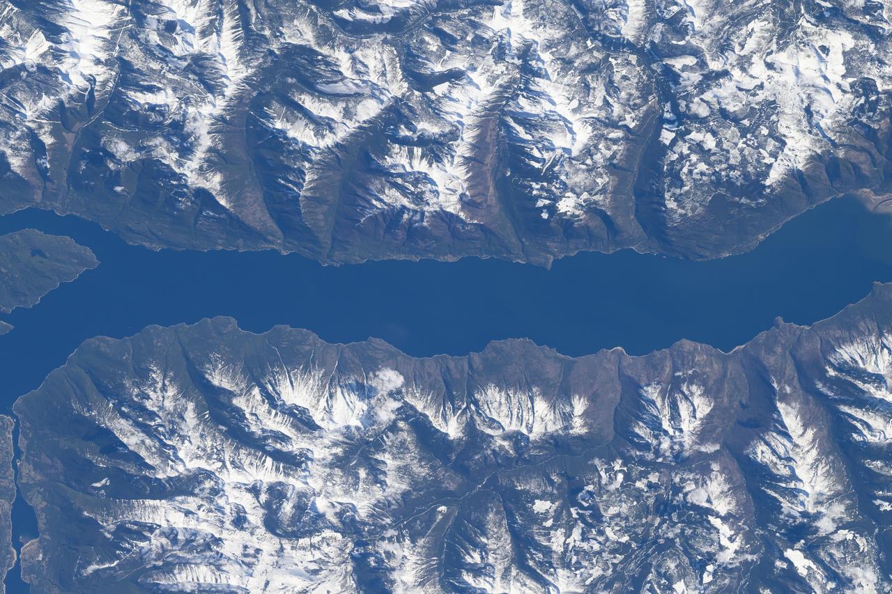 iss071e007896 (April 13, 2024) --- The southern portion of Kootenay Lake, sourrounded by the Canadian Rockies, in the Canadian province of British Columbia is pictured from the International Space Station as it orbited 260 miles above North America.