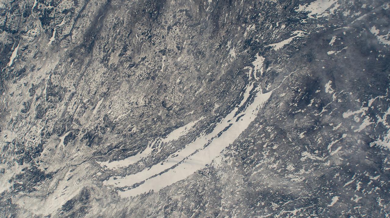 iss071e009989 (April 18, 2024) --- The ice-covered Lakes Mistassini and Albanei in Canada's Quebec province are pictured from the International Space Station as it orbited 260 miles above North America.
