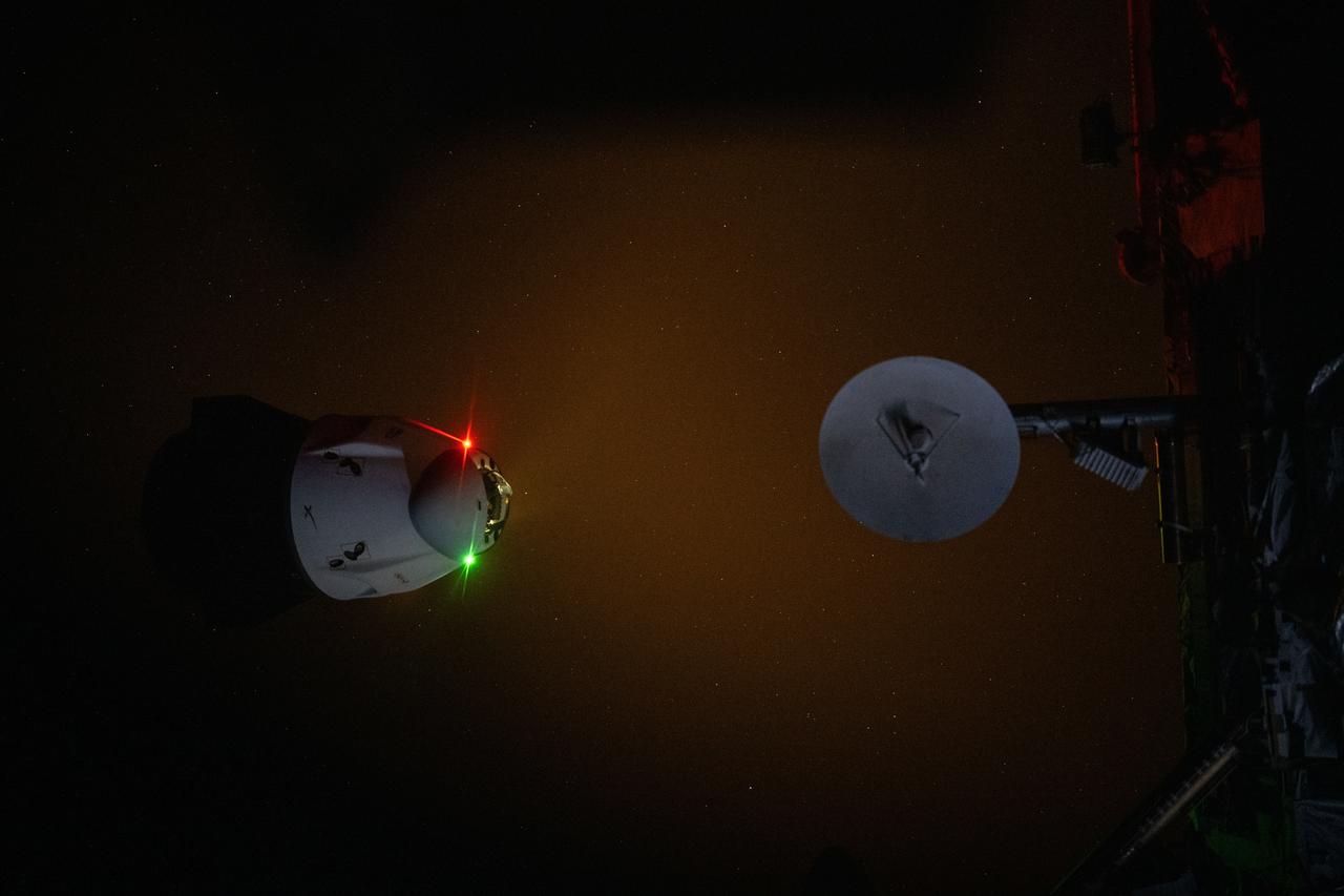 iss071e052067 (May 2, 2024) --- The SpaceX Dragon Endeavour spacecraft's navigation lights and engine plume during an engine firing illuminate the darkness of space as it backs away from the International Space Station. Dragon switched ports moving from the Harmony module's forward port to its space-facing port during the relocation maneuver.