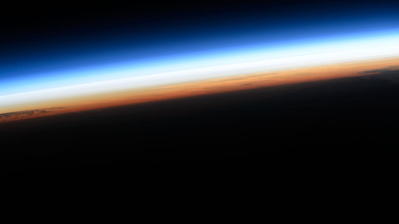 iss071e062803 (May 8, 2024) --- The last rays of an orbital sunset illuminate Earth's atmosphere in this photograph from the International Space Station as it orbited 259 miles above the Pacific Ocean.