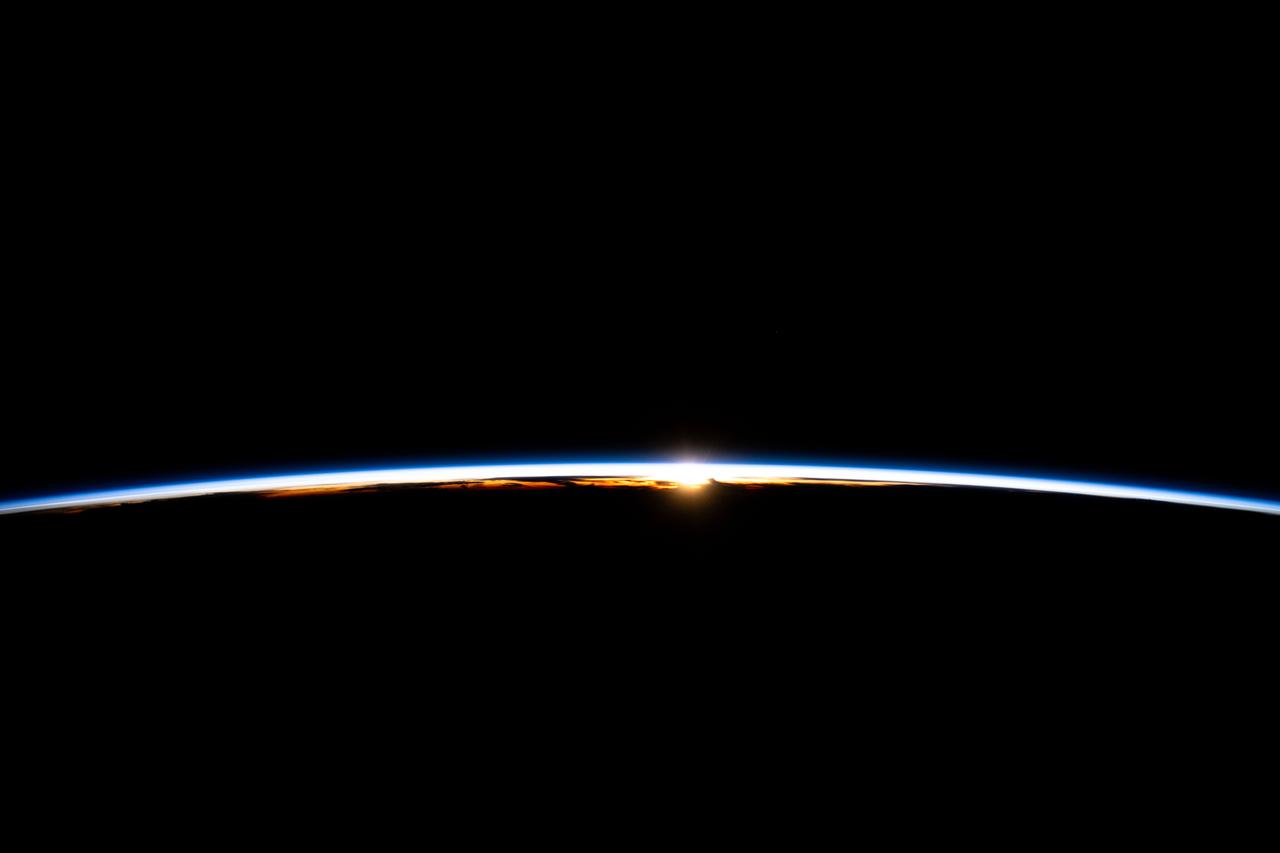 iss071e077638 (May 14, 2024) --- The first rays of an orbital sunrise break through Earth's atmosphere highlighting the cloud tops in this photograph from the International Space Station as it soared 256 miles above the Indian Ocean off the coast of Sumatra, Indonesia.