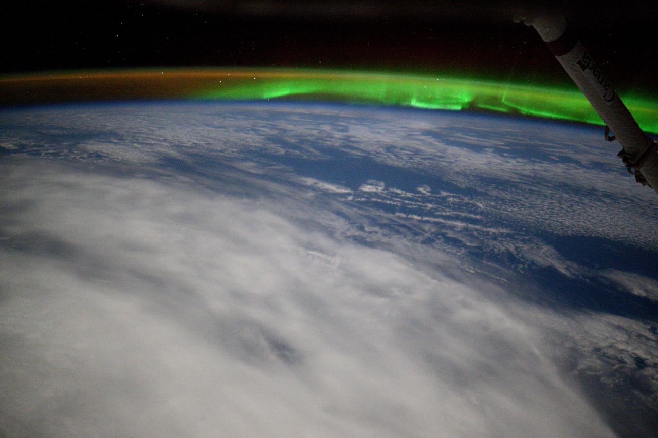 iss071e117686 (May 25, 2024) --- An aurora and an atmospheric glow crown Earth's horizon in this photograph from the International Space Station as it orbited 263 miles above a cloudy Indian Ocean southeast of Africa.