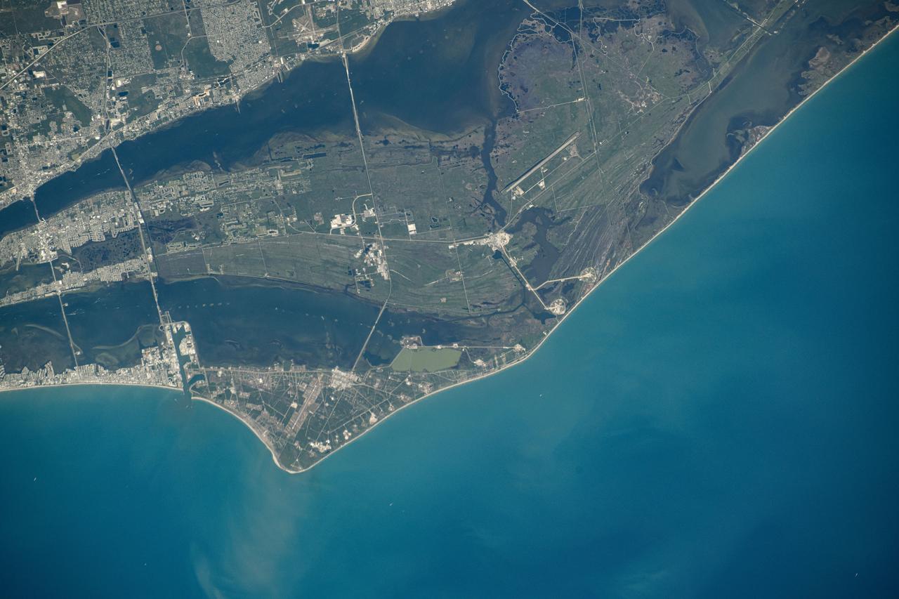 iss071e130759 (May 27, 2024) --- NASA's John F. Kennedy Space Center, the center's Launch Pads 39A and 39B, and the Cape Canaveral Space Force Station on Florida's Atlantic coast are pictured from the International Space Station as it orbited 261 miles above.