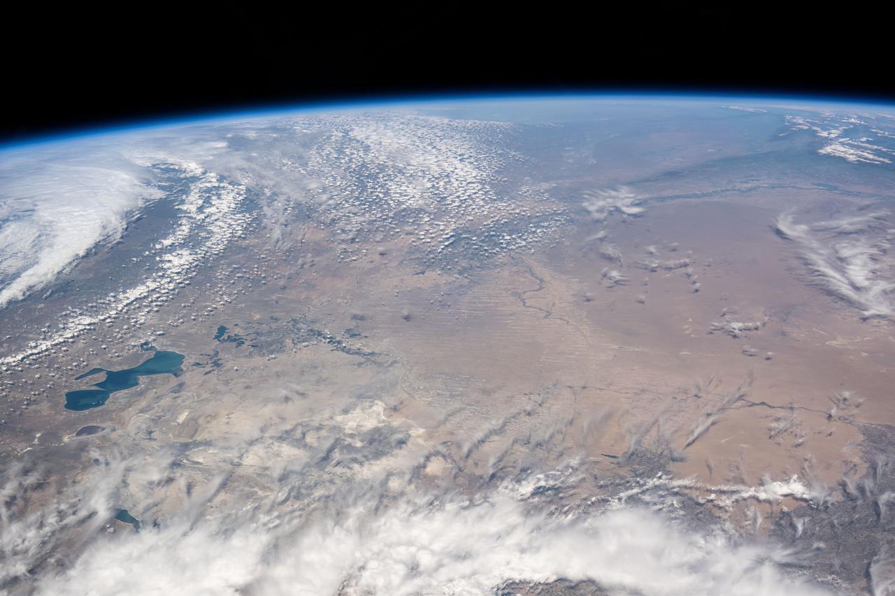 iss071e139808 (May 27, 2024) --- The North Aral Sea (at left) is seemingly dwarfed by the vast landscape of Kazakhstan in this photograph from the International Space Station as it was orbiting 262 miles above.