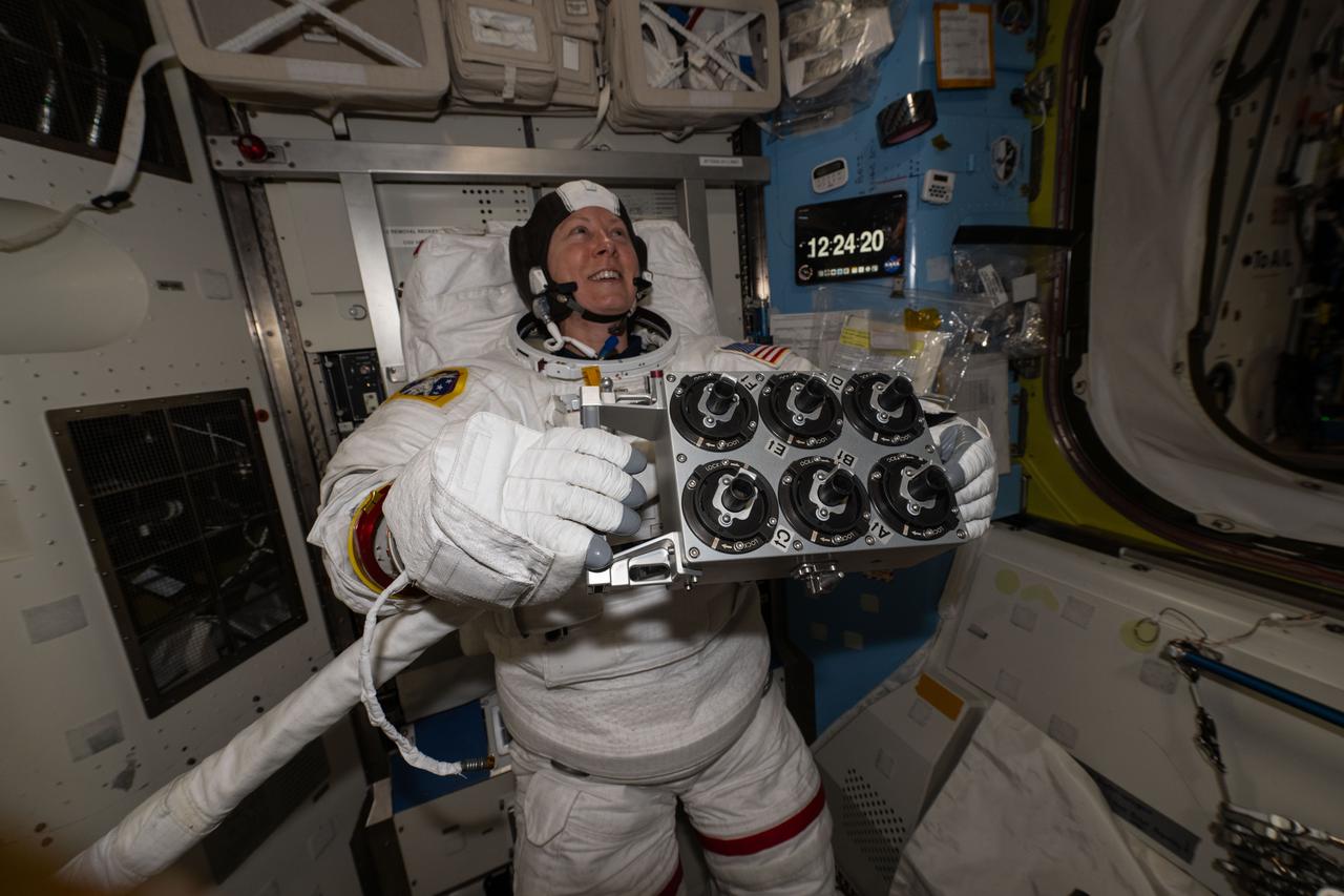 iss071e143783 (May 30, 2024) --- Expedition 71 Flight Engineer and NASA astronaut Tracy C. Dyson is pictured during a spacesuit fit check and holding spacewalk hardware inside the International Space Station's Quest airlock.