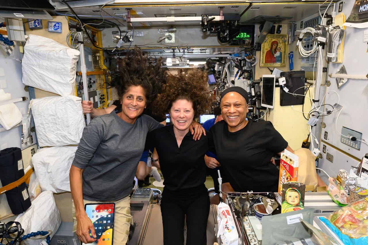 iss071e178365 (June 9, 2024) --- NASA astronauts (from left) Suni Williams, Tracy C. Dyson, and Jeanette Epps pose for a portrait during dinner time aboard the International Space Station's Unity module. Williams is the pilot for NASA's Boeing Crew Flight Test and Dyson and Epps are both Expedition 71 Flight Engineers.