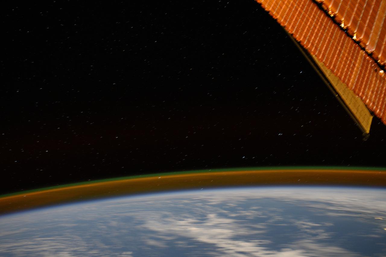 iss071e207178 (June 23, 2024) -- A long exposure shot taken aboard the International Space Station shows a golden atmospheric glow crowning Earth's horizon as the orbiting laboratory soared 267 miles over the South Pacific Ocean.