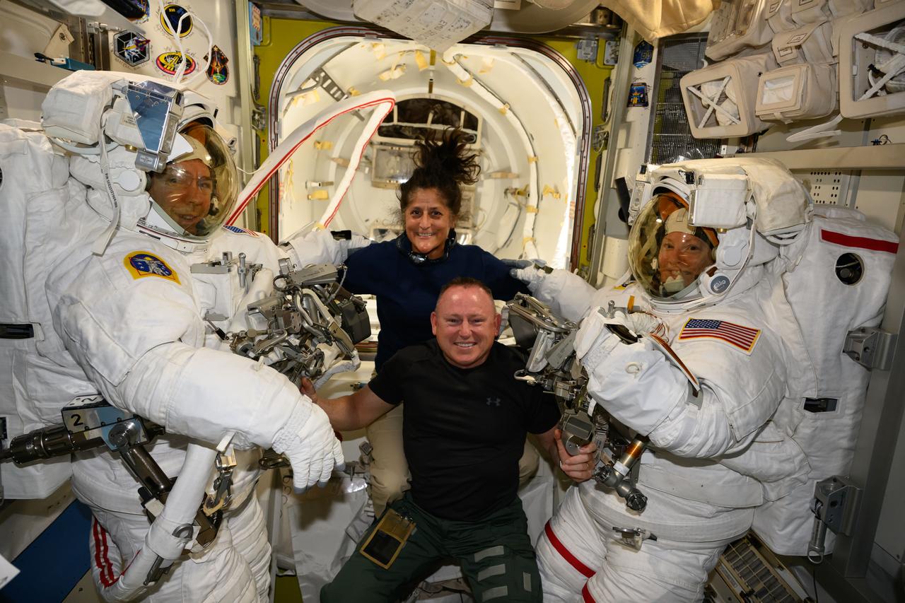 iss071e207890 (June 24, 2024) --- NASA's Boeing Crew Flight Test astronauts Suni Williams and Butch Wilmore (at center) pose with Expedition 71 Flight Engineers (far left) Mike Barratt and Tracy C. Dyson (far right), both NASA astronauts, in their spacesuits aboard the International Space Station's Quest airlock.