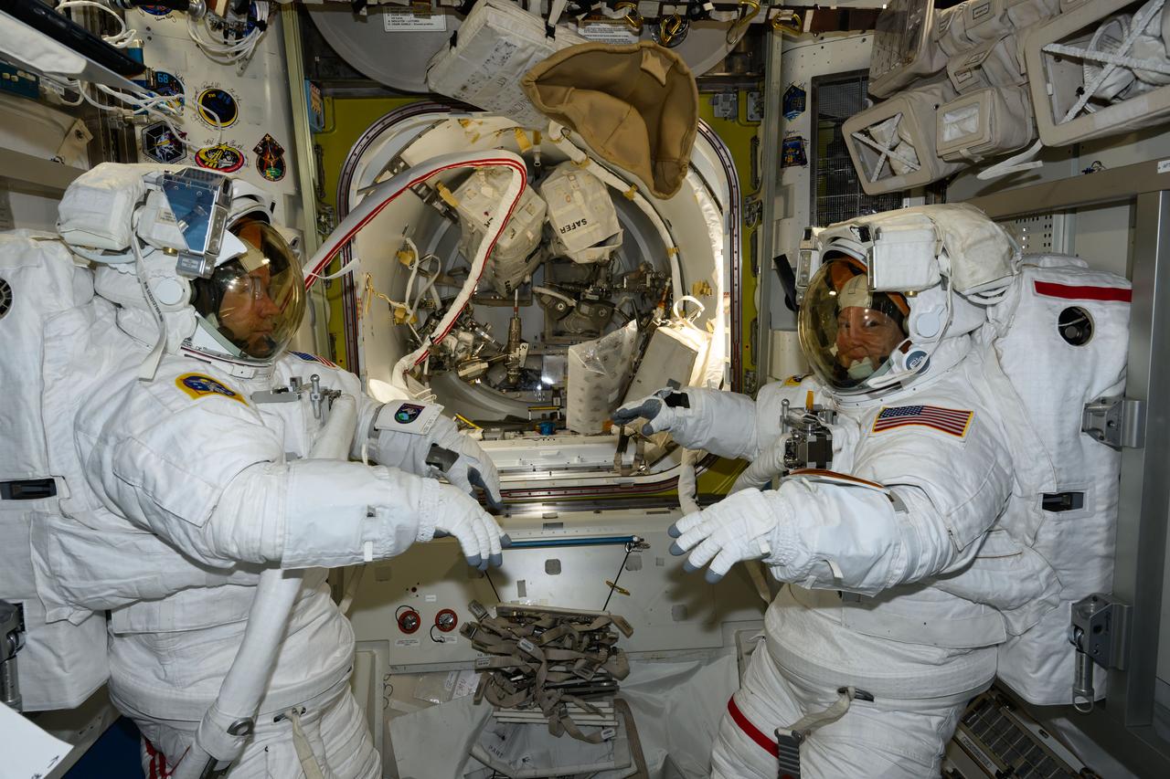 iss071e208018 (June 24, 2024) --- NASA astronauts (from left) Mike Barratt and Tracy C. Dyson, both Expedition 71 Flight Engineers, are pictured in the Quest airlock prior to the start of a science and maintenance spacewalk that ended early after Dyson's suit experienced a water leak in the service and cooling umbilical unit.