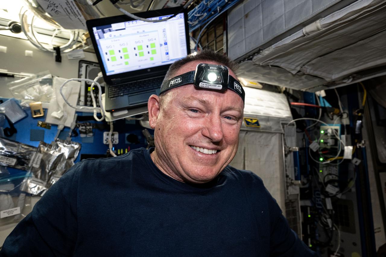 iss071e235668 (June 27, 2024) --- NASA astronaut and Boeing Crew Flight Test Commander Butch Wilmore smiles for a portrait in the middle of orbital maintenance duties aboard the International Space Station's Harmony module.