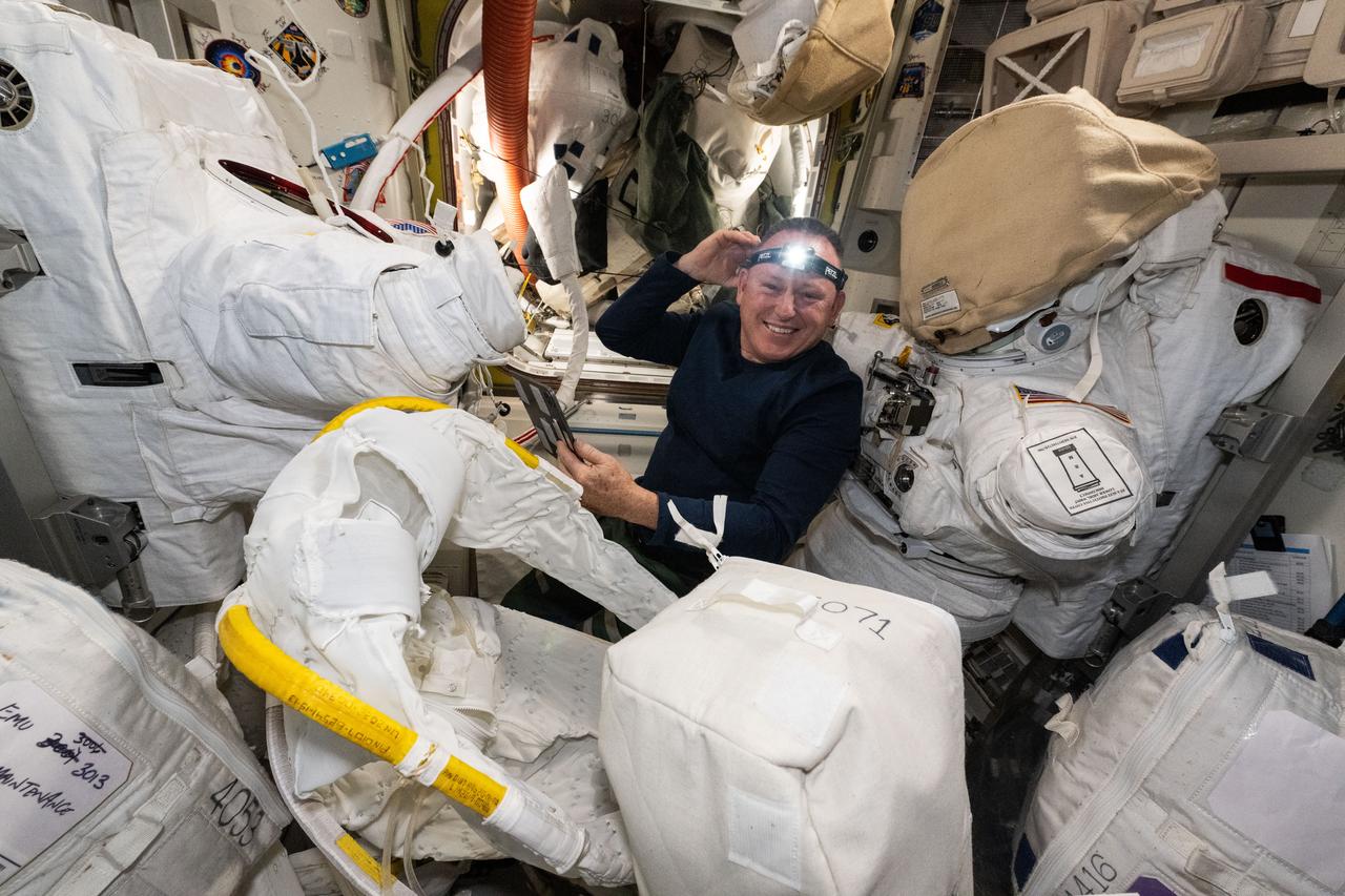 iss071e321395 (July 11, 2024) --- NASA astronaut and Boeing Crew Flight Test Commander Butch Wilmore performs spacesuit maintenance inside the International Space Station's Quest airlock.