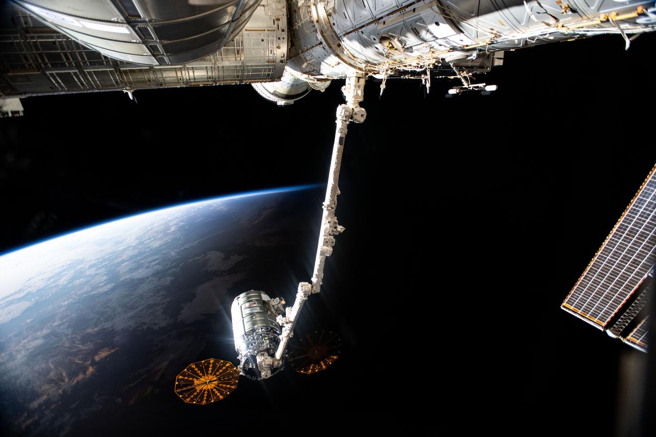 iss071e329922 (July 12, 2024) -- Northrop Grumman's Cygnus space freighter is pictured attached to the Canadarm2 robotic arm ahead of its release from the International Space Station's Unity module. The orbiting lab and Cygnus were soaring into orbital daytime as this photo was taken.