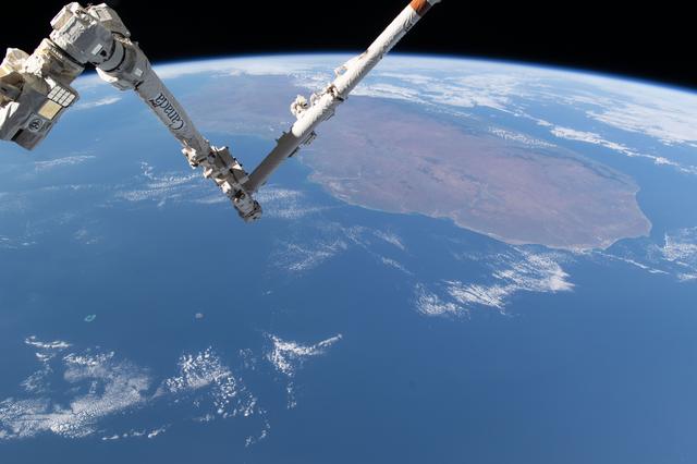 NASA image: The Canadarm2 robotic arm above the Mozambique Channel