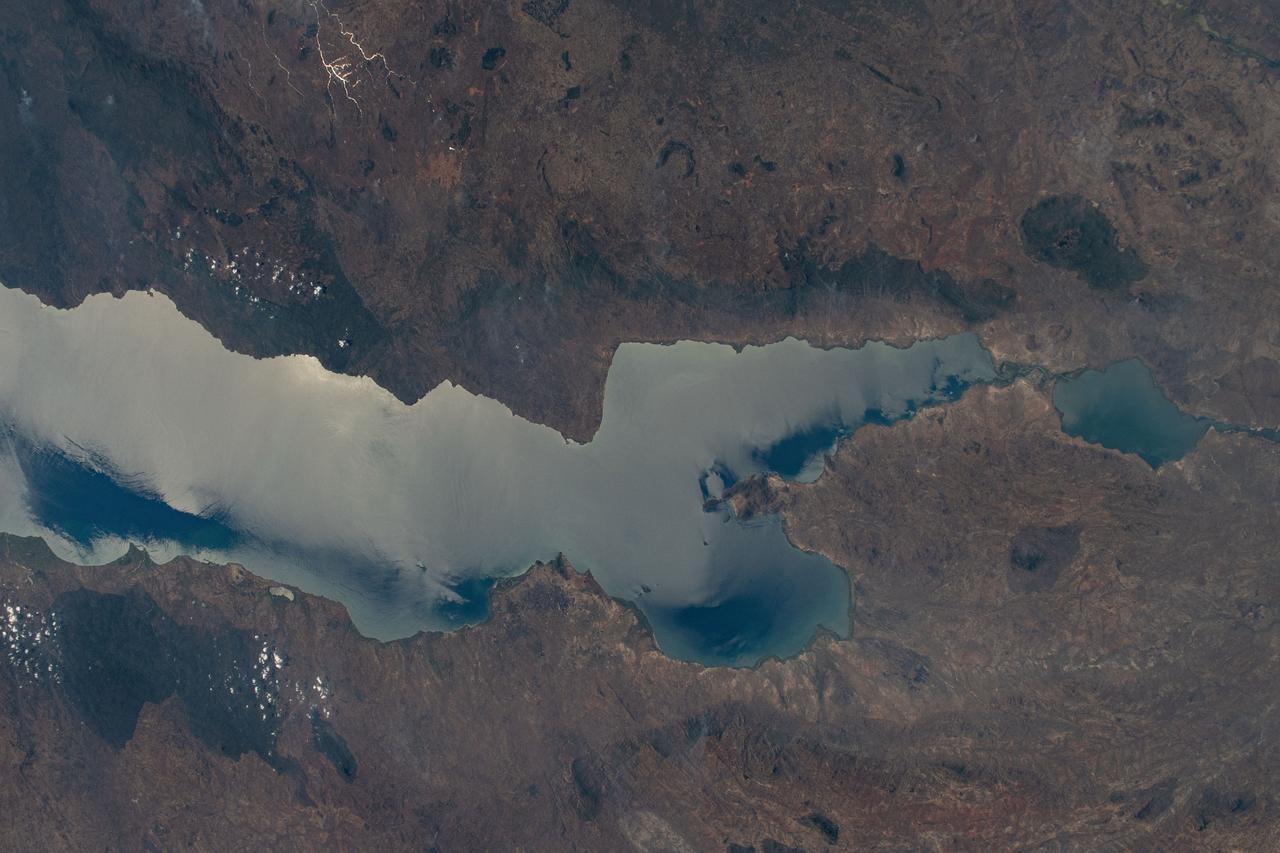 iss071e378491 (July 21, 2024) -- Sunlight reflects off the freshwater of Kasankha Bay, located in the southern region of Lake Malawi, creating a near glass-like appearance. One of seven African Great Lakes, Malawi ranks as one of the deepest lakes in the world. As the International Space Station soared 262 miles above the Great Rift Valley, NASA astronaut Matthew Dominick captured this photo.